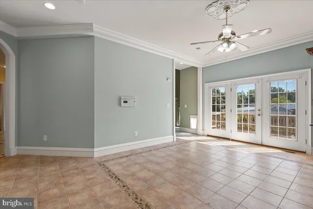 a view of an empty room with a fireplace and a window