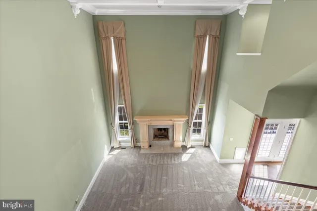 a view of an empty room with a cabinet and a window