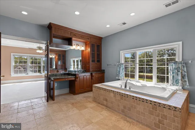 a view of an empty room with closet and a window