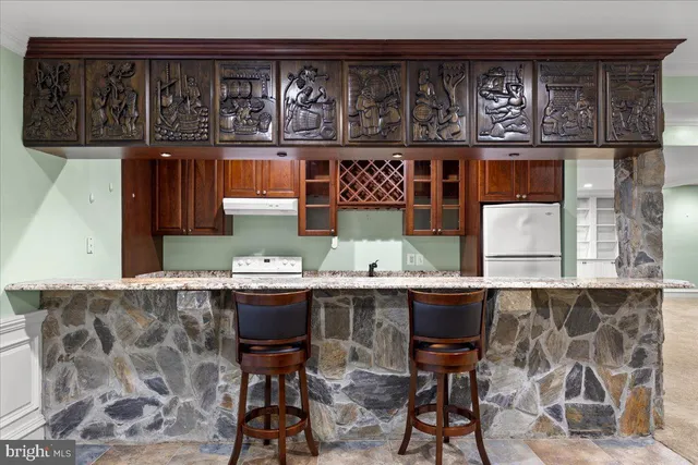 a kitchen with a table and chairs in it