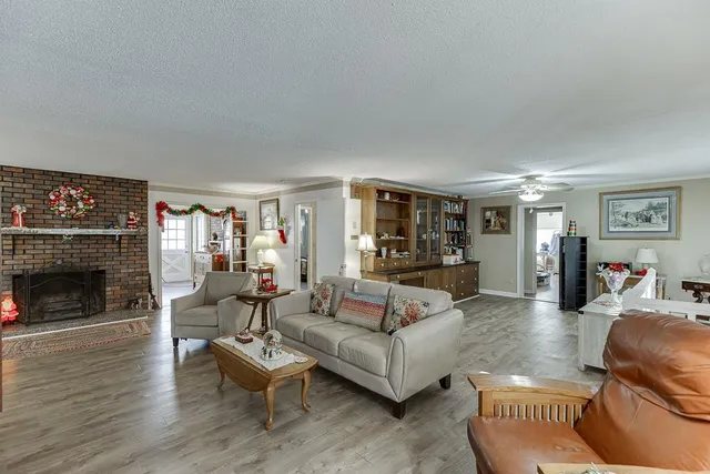a living room with furniture and view of kitchen