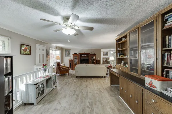 a living room with furniture and view of kitchen