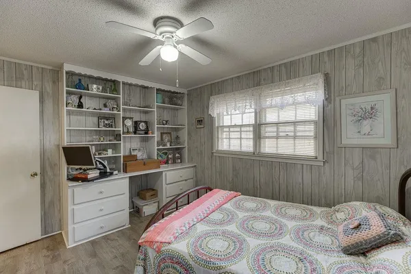 a large bedroom with a bed and a chandelier