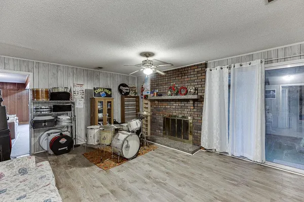 a living room with furniture a dining table and chairs with wooden floor