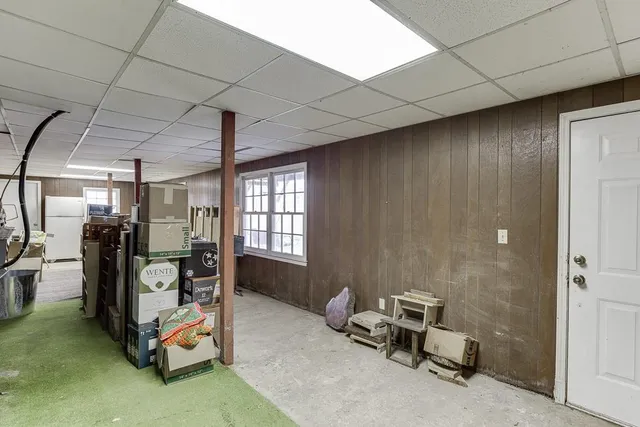 a view of an house with backyard and trees