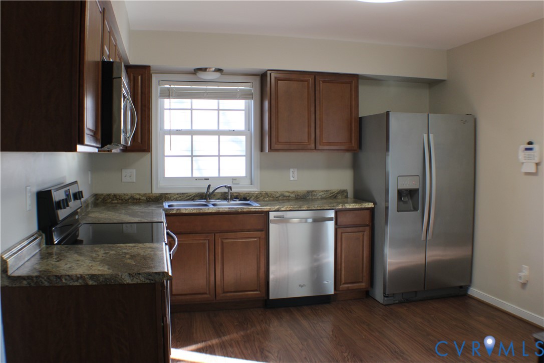 2929 South Ridge Drive Midlothian, VA 23112 - Photo 11 of 37 a kitchen with granite countertop stainless steel appliances a sink cabinets and a window