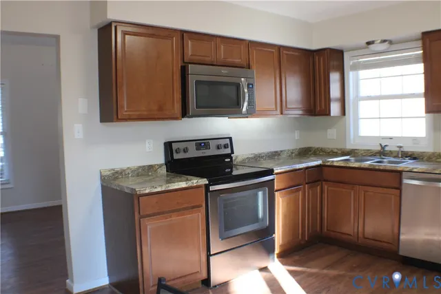 a view of a yard with plants and trees