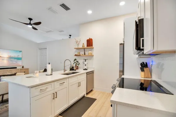 a kitchen with stainless steel appliances a stove refrigerator sink and cabinets