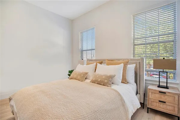 a bed room with a bed and a night stand