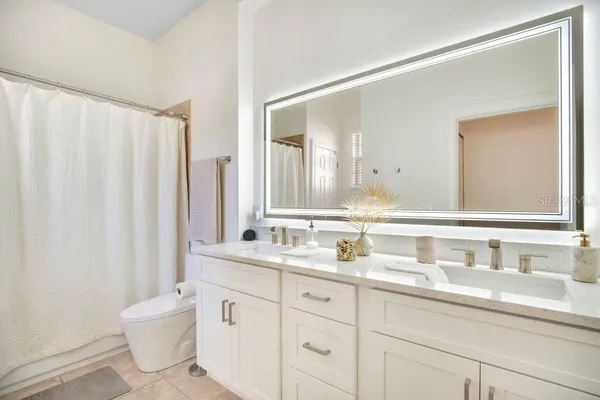 a view of walk in closet with clothes