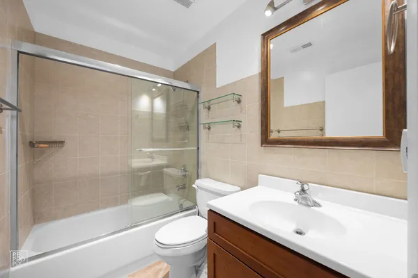 a bathroom with a sink mirror toilet and bathtub