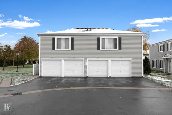 a view of a white house with a outdoor space