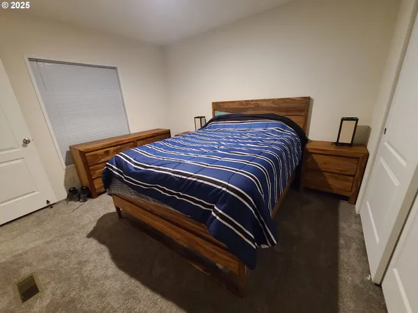 a bedroom with a bed and a mirror