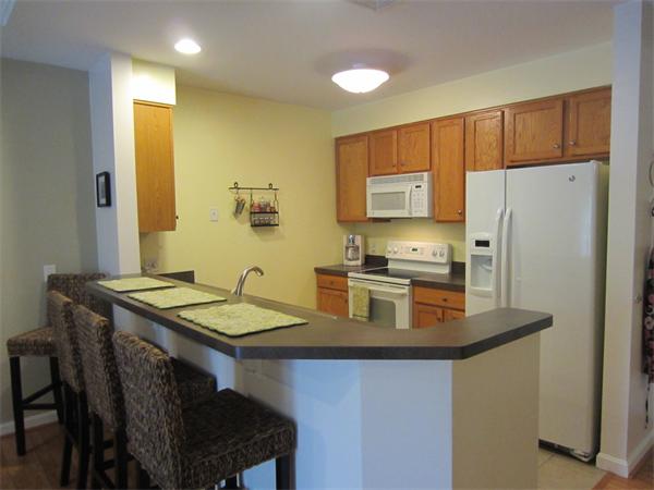 200 Chickering Road, Unit 306B North Andover, MA 01845 - Photo 7 of 30 a kitchen with kitchen island a refrigerator stove and sink