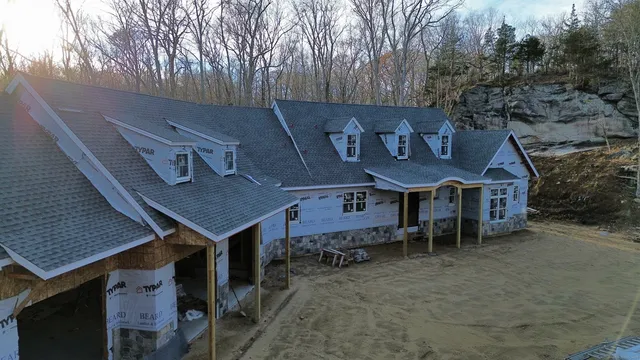 an aerial view of a house with a yard