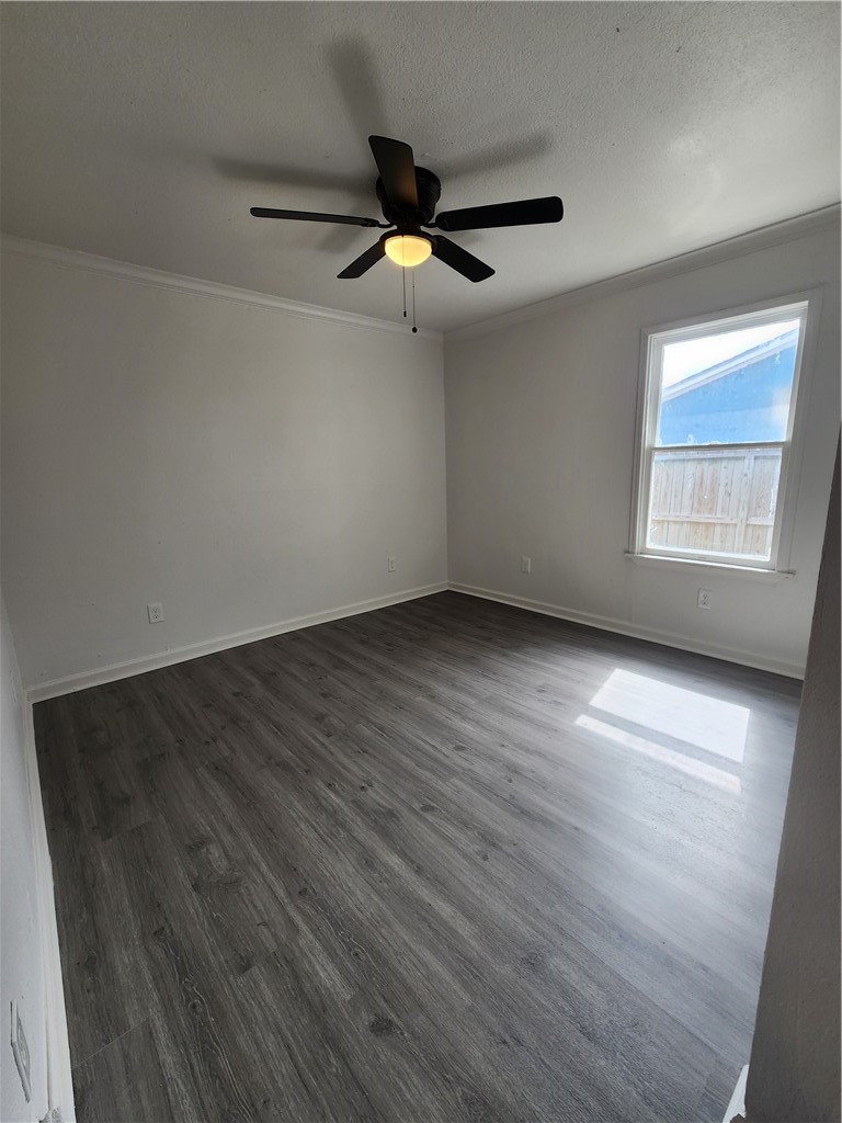 4818 Lansdown Drive Corpus Christi, TX 78411 - Photo 8 of 9 an empty room with wooden floor fan and windows