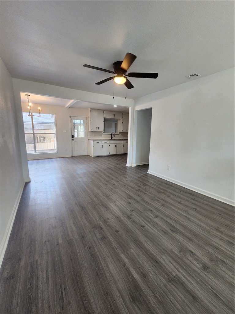4818 Lansdown Drive Corpus Christi, TX 78411 - Photo 9 of 9 a view of a livingroom with wooden floor a ceiling fan and windows