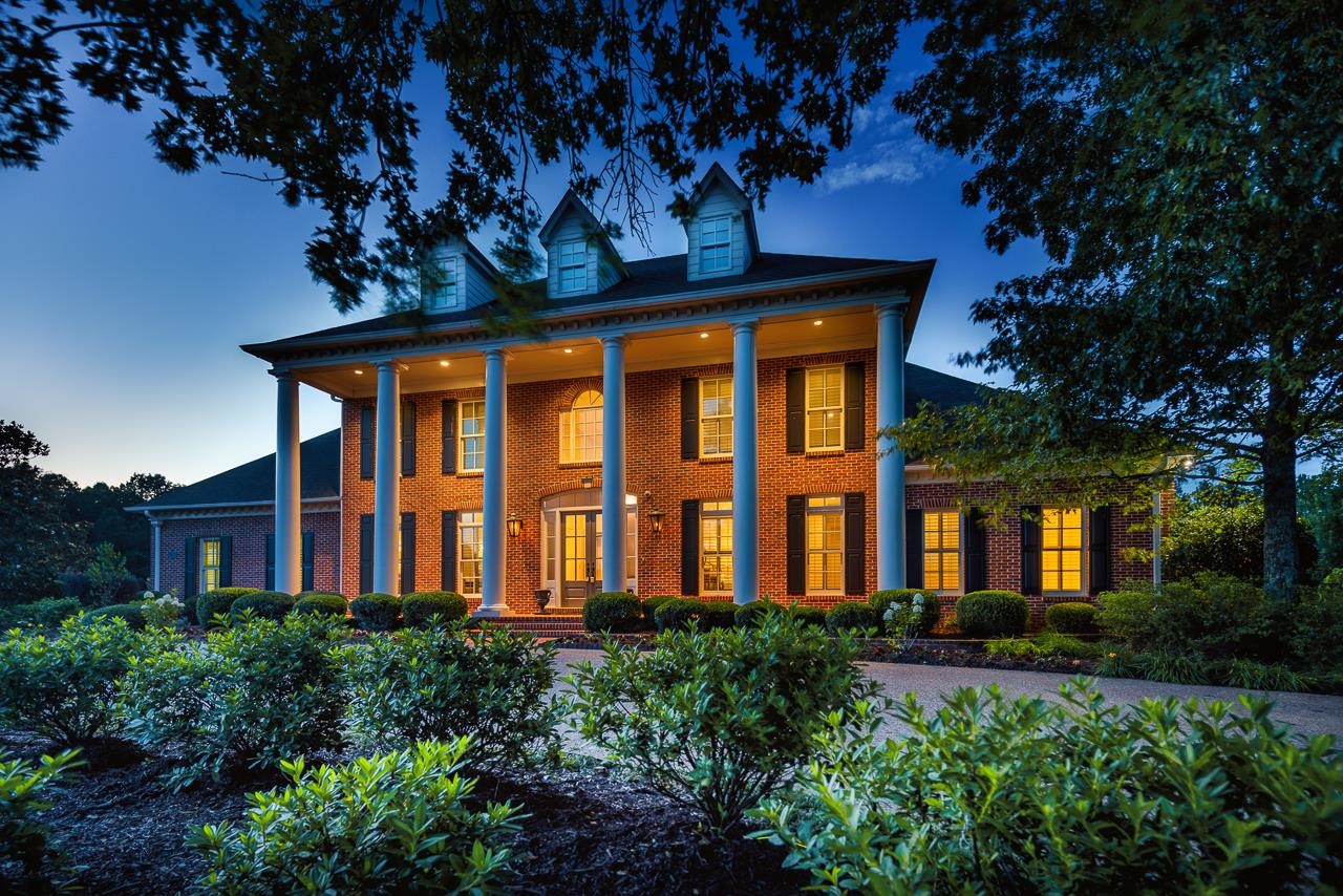 a front view of a residential apartment building with a yard