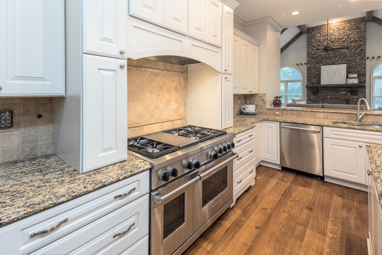 9844 Legends Drive Collierville, TN 38139 - Photo 4 of 25 a kitchen with stainless steel appliances granite countertop a stove and a sink
