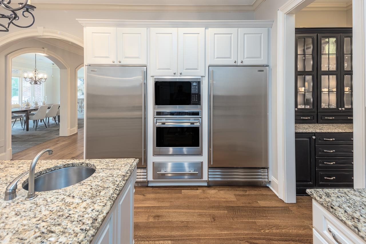 9844 Legends Drive Collierville, TN 38139 - Photo 5 of 25 a kitchen with granite countertop a refrigerator and a sink