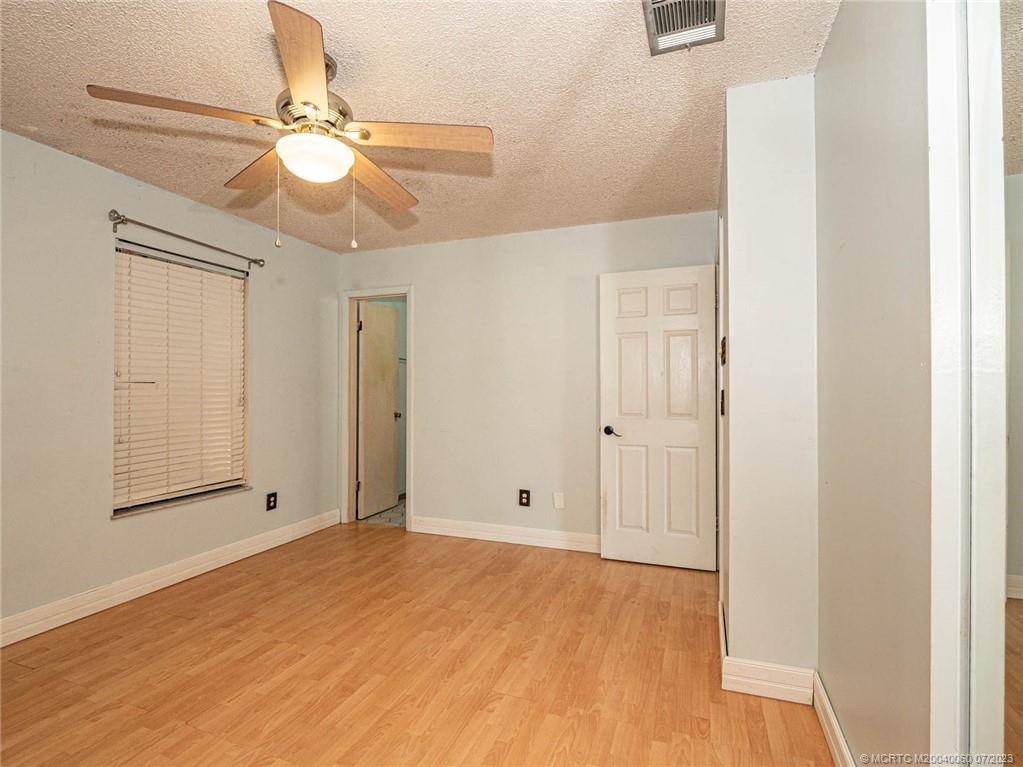 662 Southeast Ron Rico Terrace Port St. Lucie, FL 34983 - Photo 11 of 27 a view of an empty room with chandelier fan