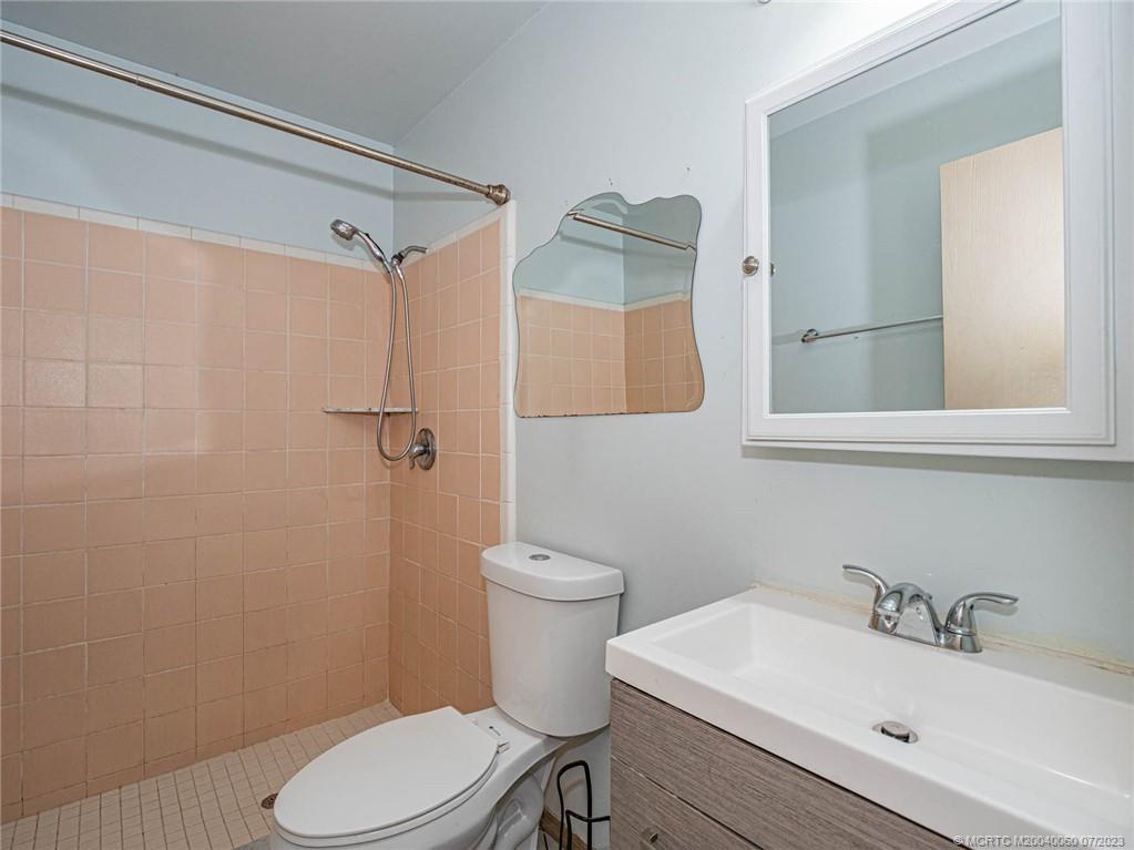 662 Southeast Ron Rico Terrace Port St. Lucie, FL 34983 - Photo 12 of 27 a bathroom with a sink a toilet and shower