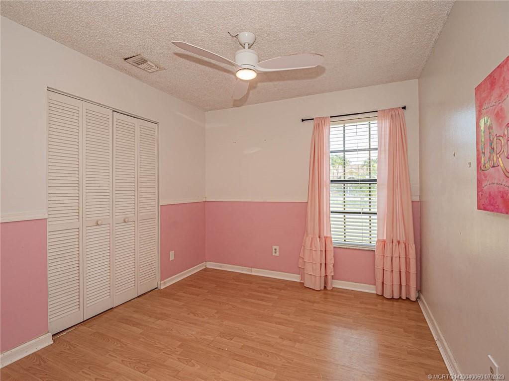 662 Southeast Ron Rico Terrace Port St. Lucie, FL 34983 - Photo 15 of 27 an empty room with windows and ceiling fan