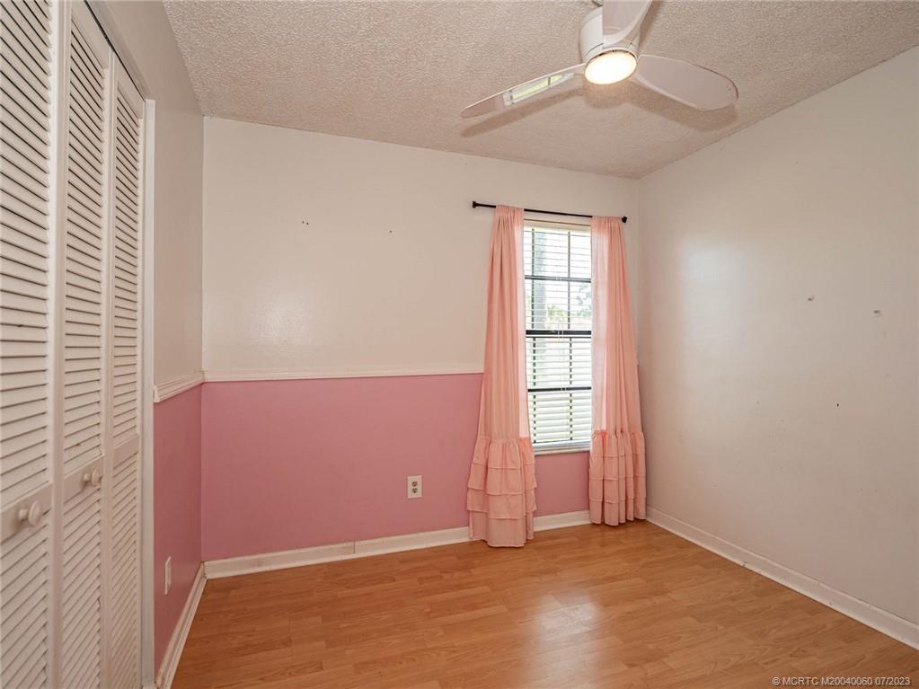662 Southeast Ron Rico Terrace Port St. Lucie, FL 34983 - Photo 16 of 27 an empty room with windows and ceiling fan
