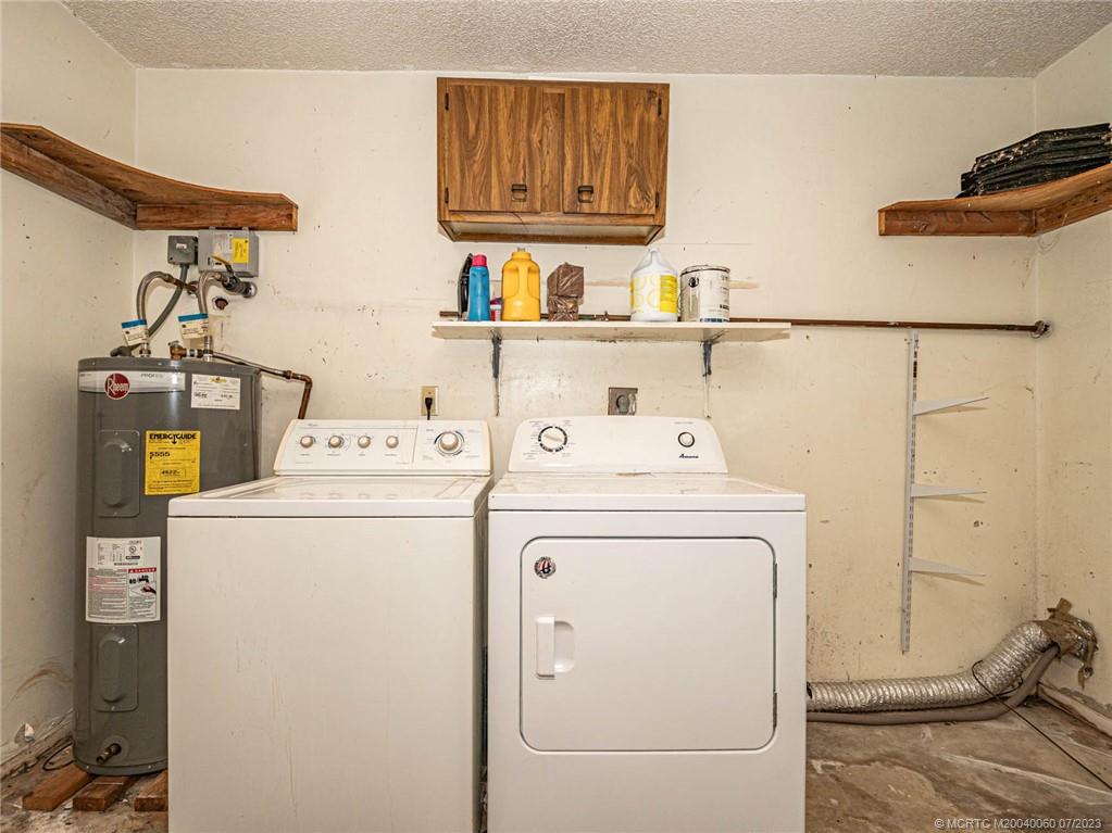662 Southeast Ron Rico Terrace Port St. Lucie, FL 34983 - Photo 18 of 27 a utility room with dryer and washer