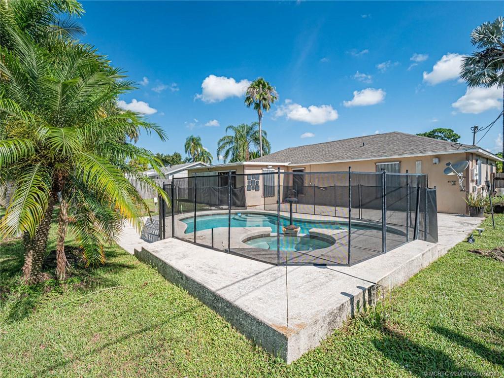 662 Southeast Ron Rico Terrace Port St. Lucie, FL 34983 - Photo 21 of 27 a view of a backyard with a garden