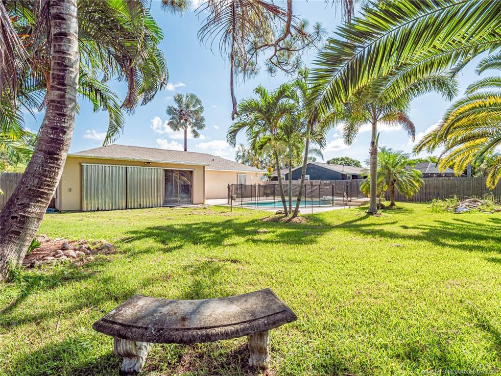 662 Southeast Ron Rico Terrace Port St. Lucie, FL 34983 - Photo 23 of 27 a house with swimming pool in front of it