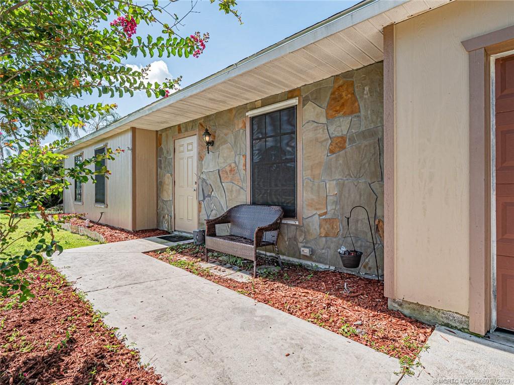 662 Southeast Ron Rico Terrace Port St. Lucie, FL 34983 - Photo 24 of 27 a outdoor seating area with furniture and a potted plant