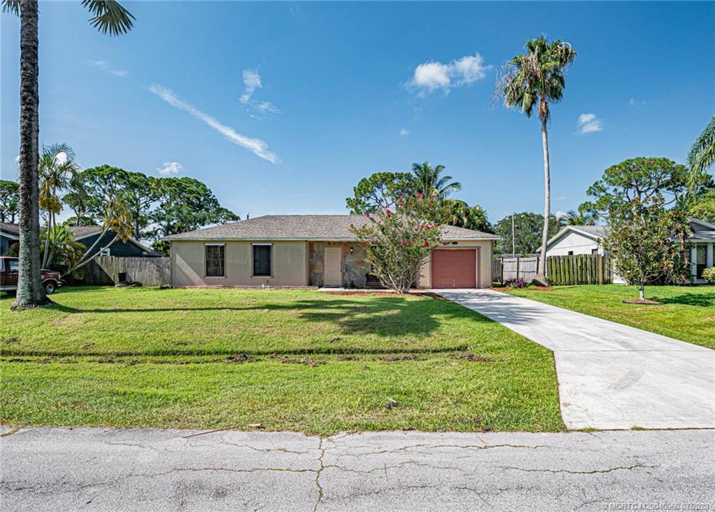 662 Southeast Ron Rico Terrace Port St. Lucie, FL 34983 - Photo 27 of 27 a front view of a house with a yard