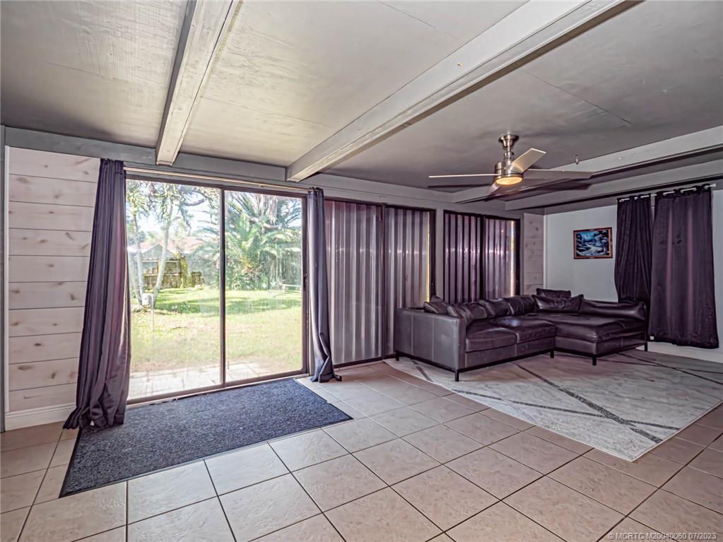 662 Southeast Ron Rico Terrace Port St. Lucie, FL 34983 - Photo 8 of 27 a living room with furniture and a floor to ceiling window