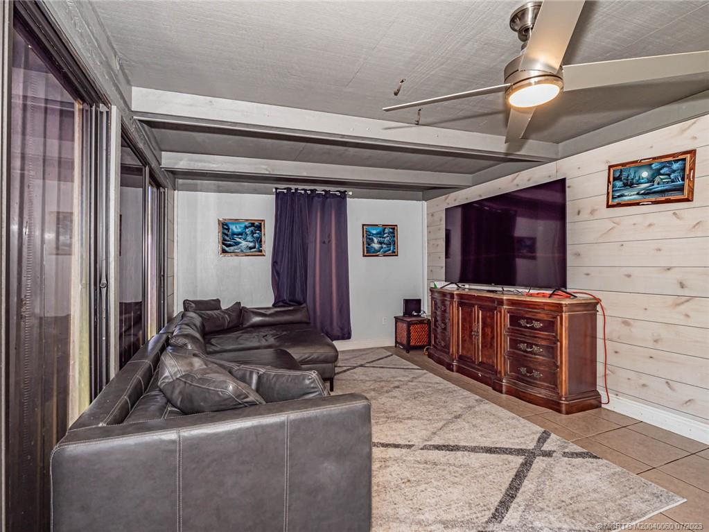 662 Southeast Ron Rico Terrace Port St. Lucie, FL 34983 - Photo 9 of 27 a living room with furniture and a flat screen tv