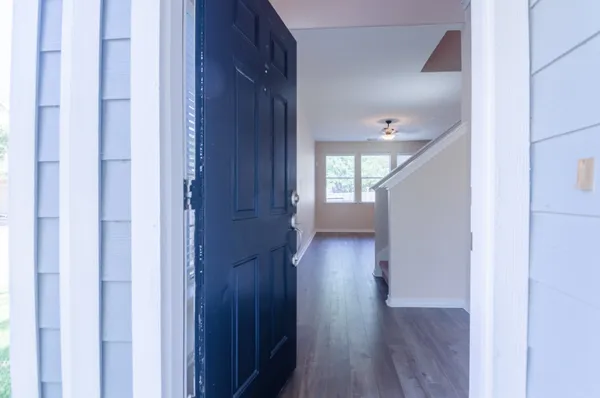 a view of a hallway with wooden floor