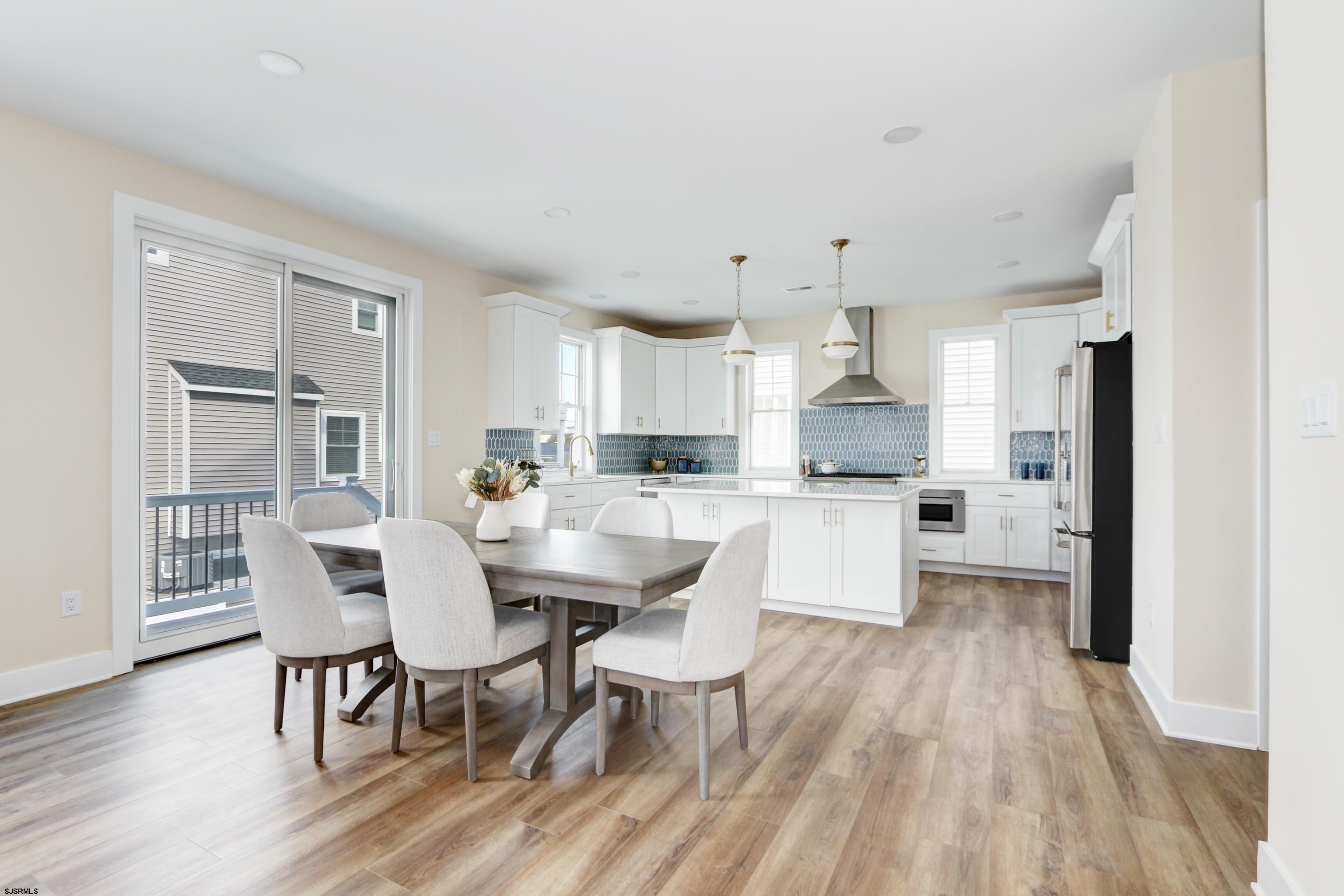 303 Lafayette Place Brigantine, NJ 08203 - Photo 11 of 38 a view of a dining room with furniture wooden floor and chandelier