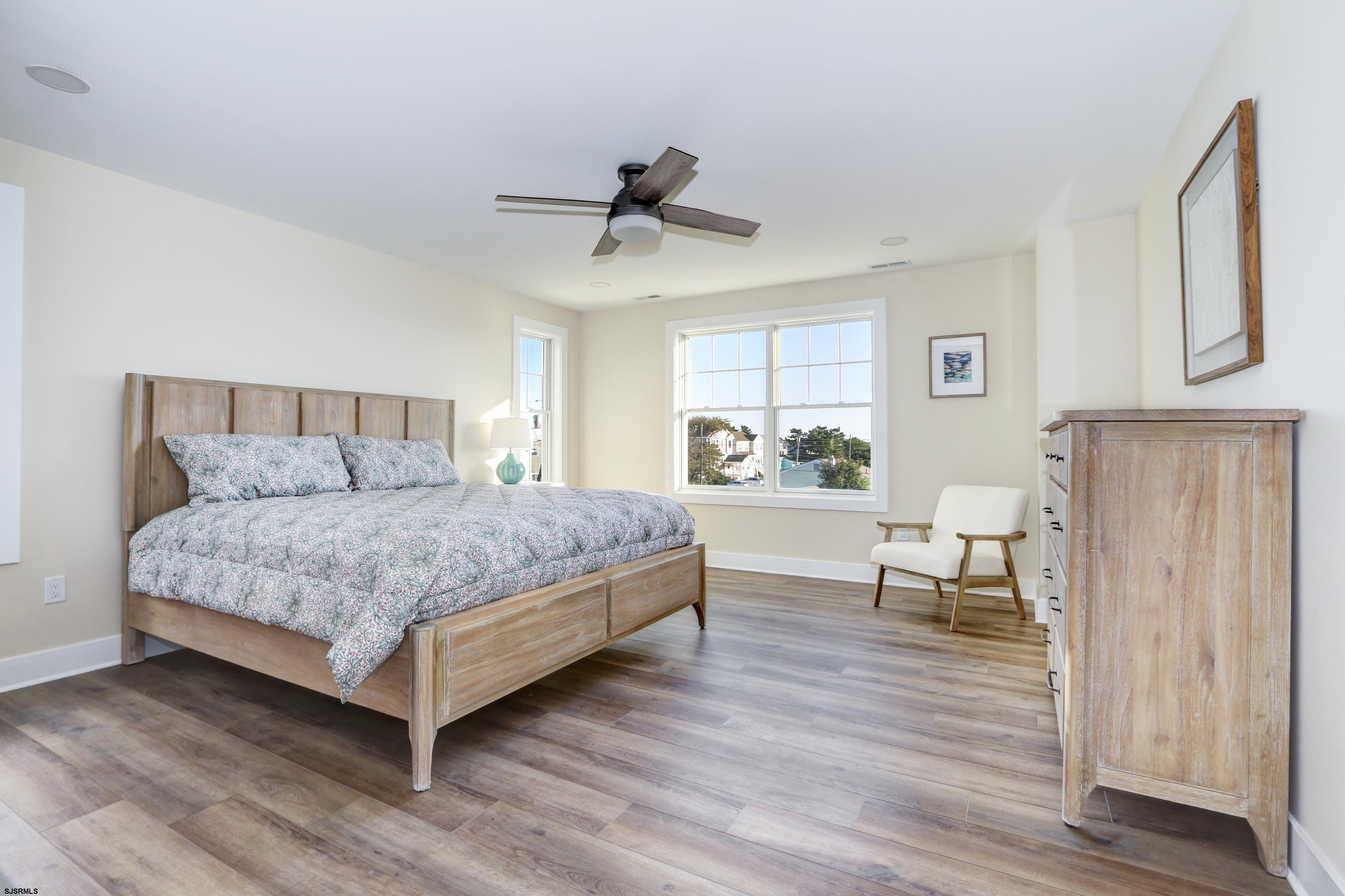 303 Lafayette Place Brigantine, NJ 08203 - Photo 16 of 38 a bedroom with a bed a mirror and a window