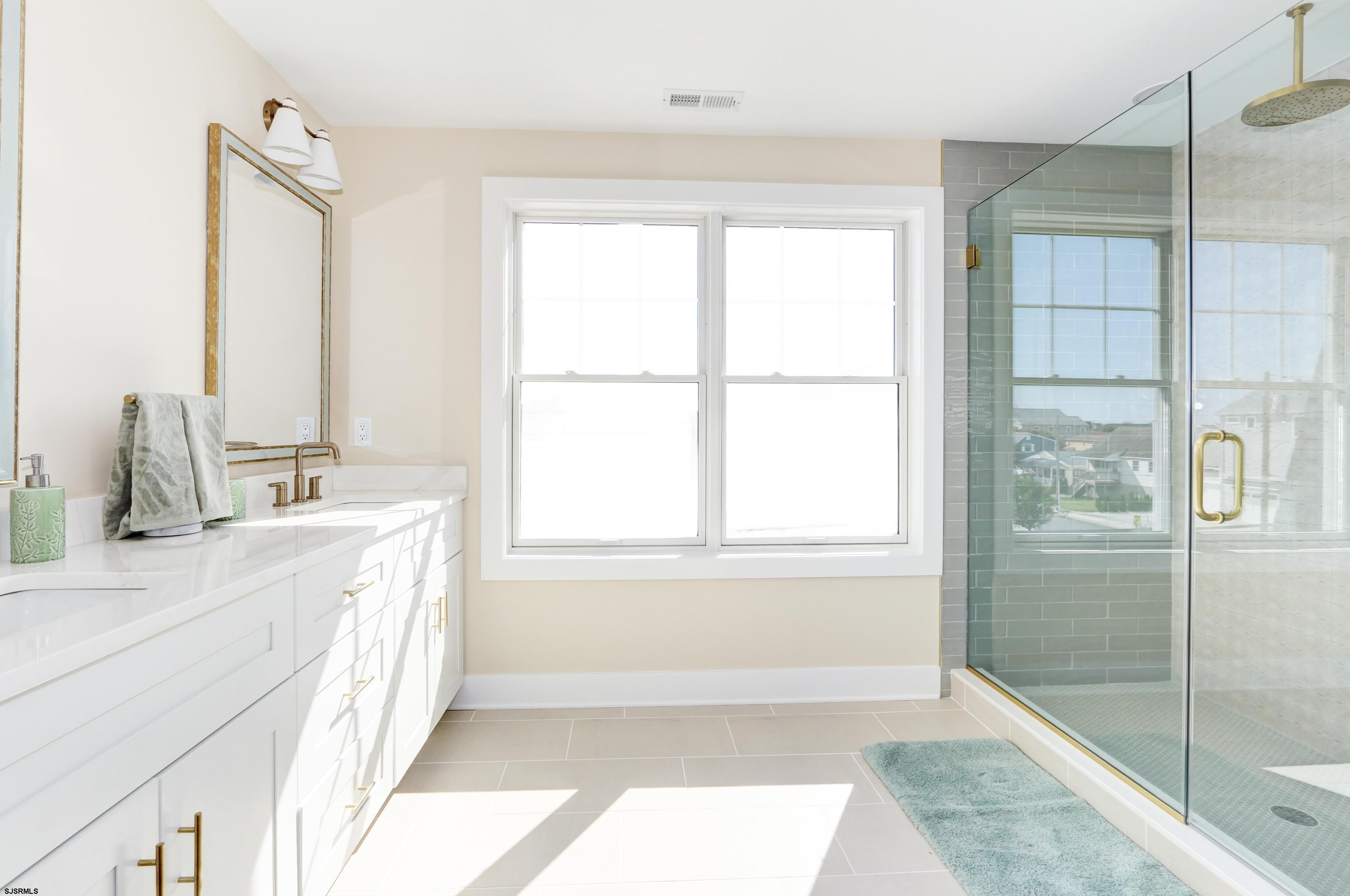 303 Lafayette Place Brigantine, NJ 08203 - Photo 19 of 38 a bathroom with a tub sink and shower