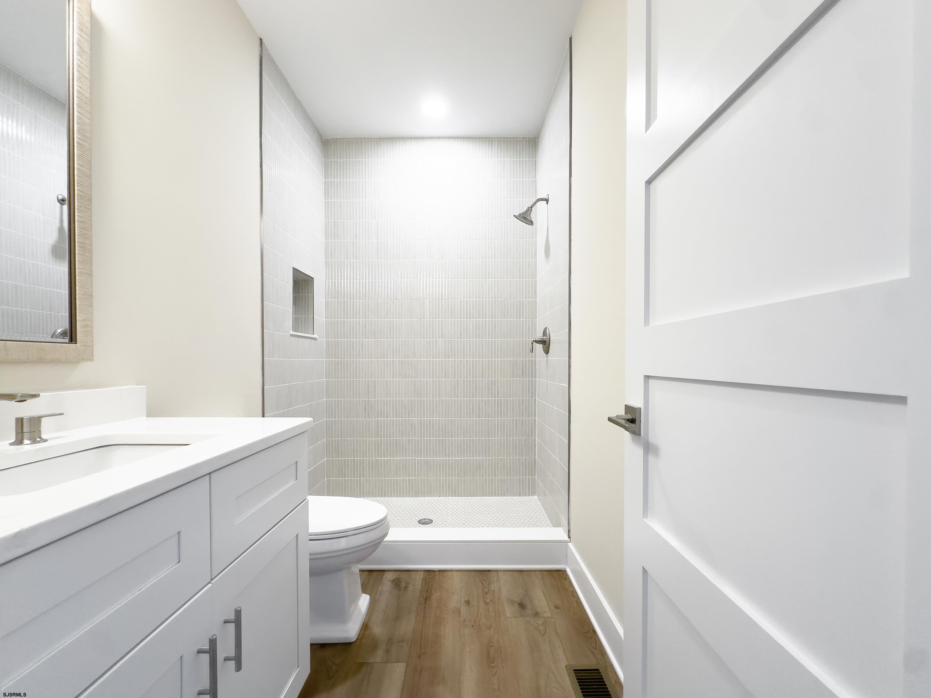 303 Lafayette Place Brigantine, NJ 08203 - Photo 25 of 38 a bathroom with a sink a toilet a shower and a bathtub