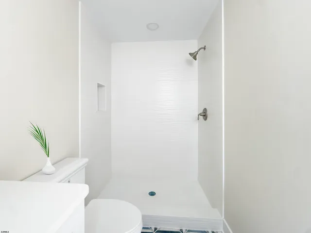 a utility room with cabinets washer and dryer