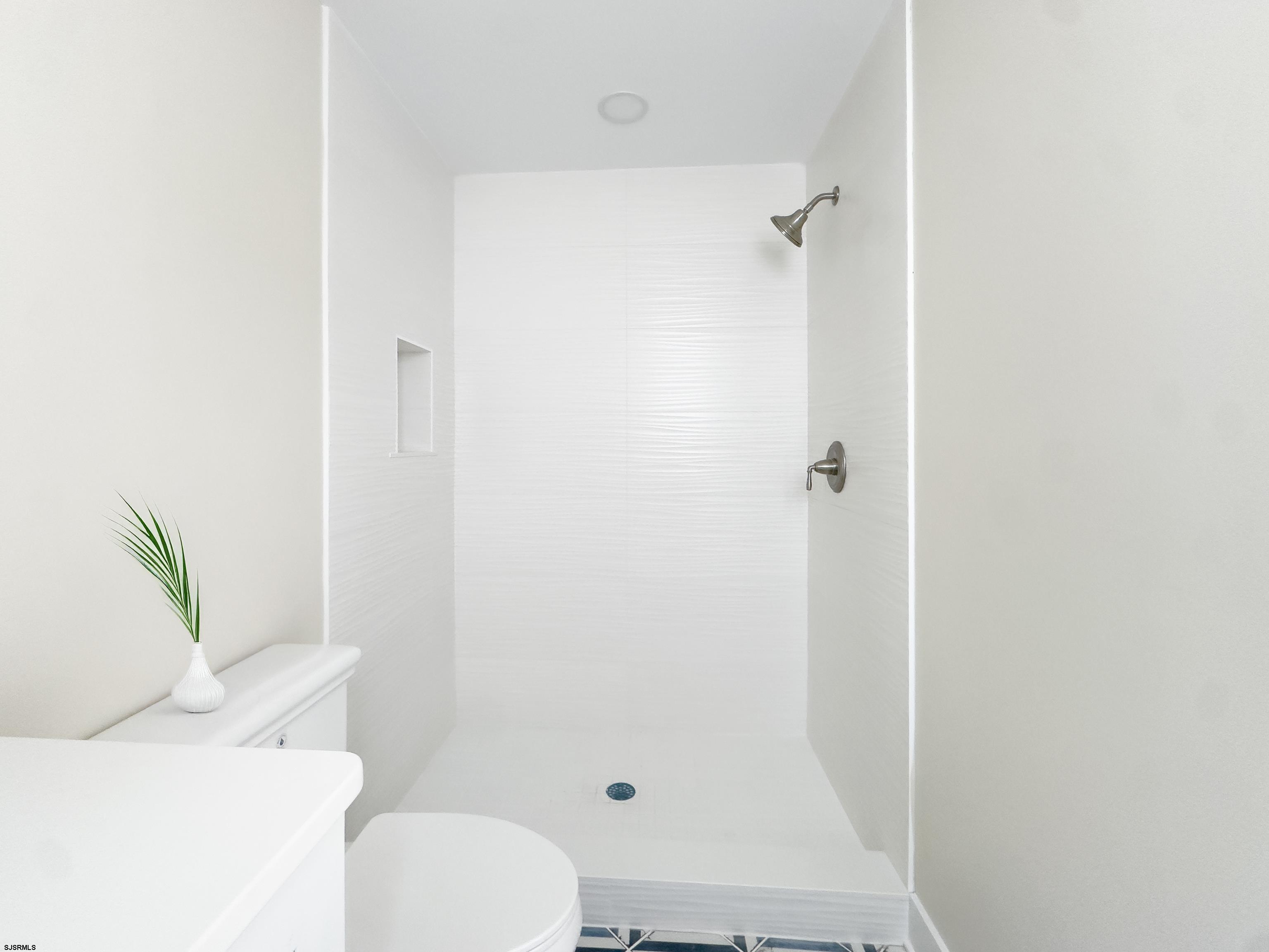 303 Lafayette Place Brigantine, NJ 08203 - Photo 29 of 38 a bathroom with a toilet and shower