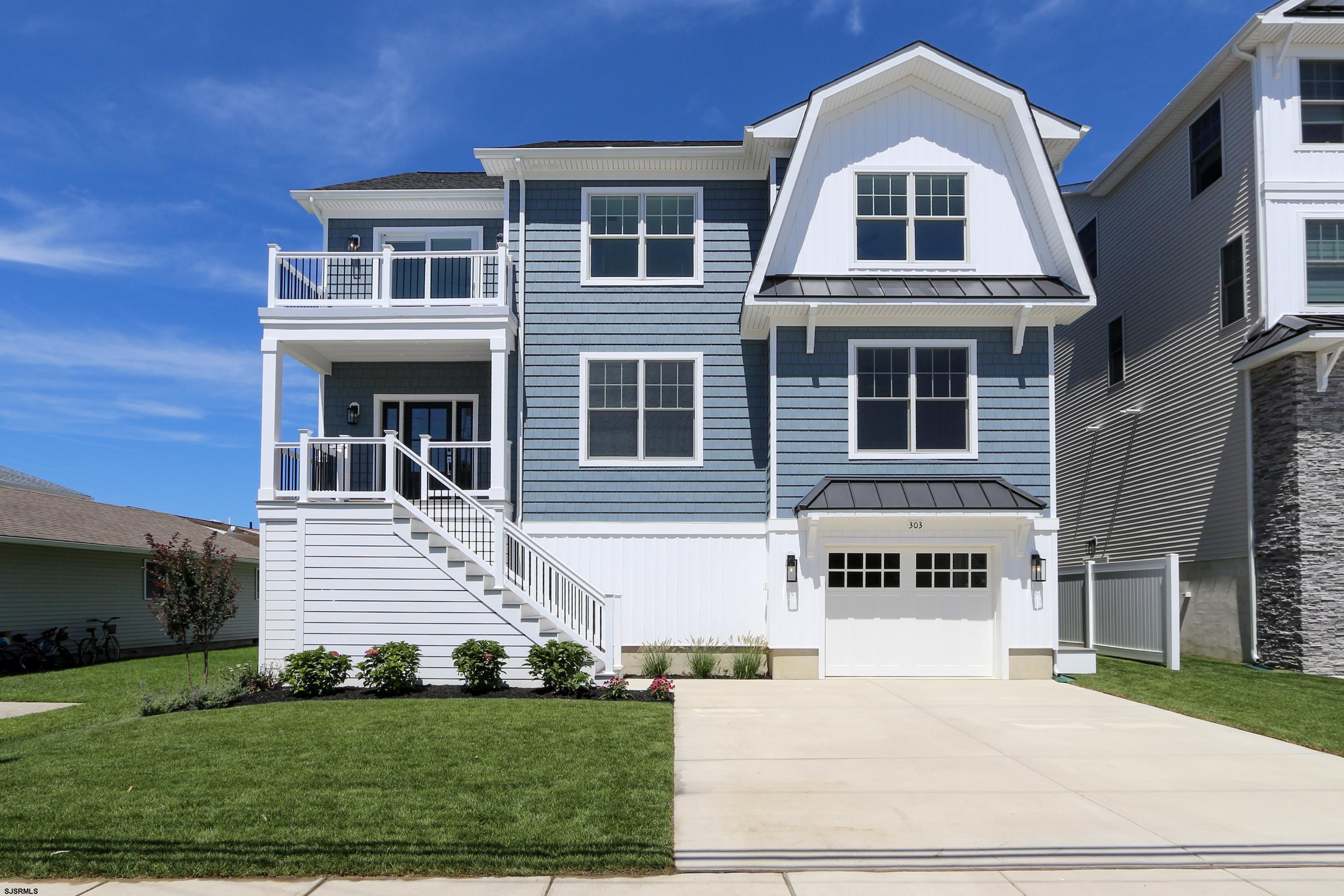 303 Lafayette Place Brigantine, NJ 08203 - Photo 3 of 38 a front view of a house with a yard