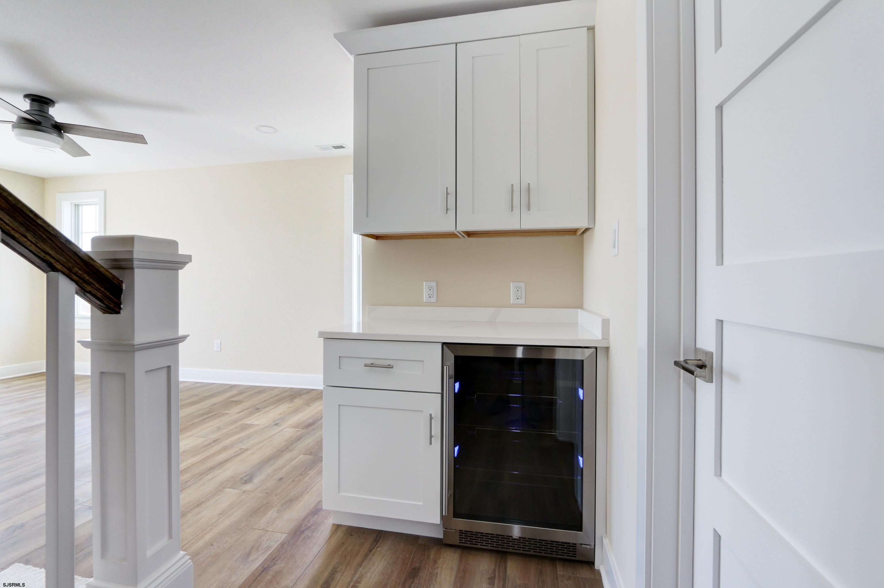 303 Lafayette Place Brigantine, NJ 08203 - Photo 33 of 38 a kitchen with a white cabinets and a stove