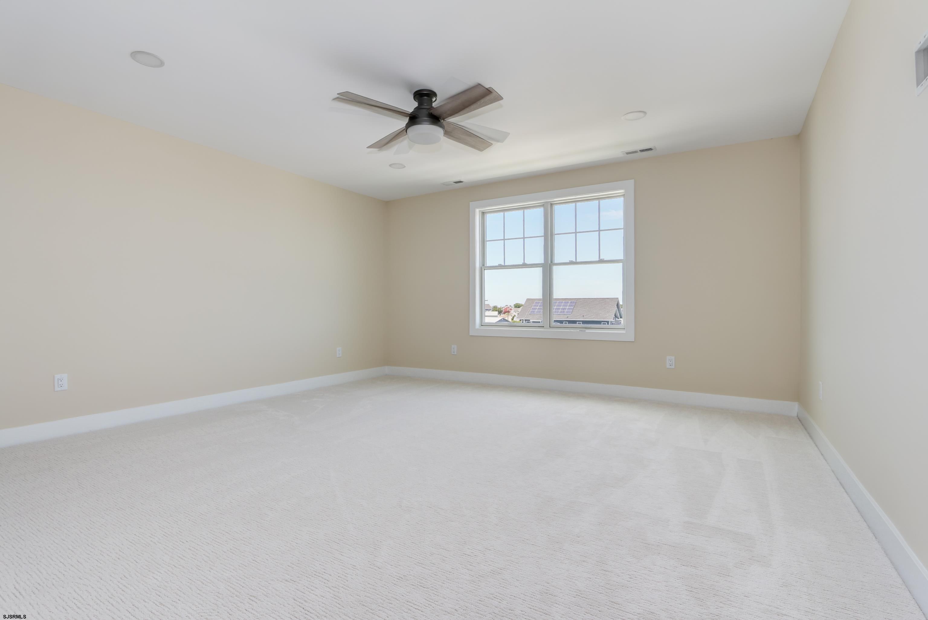 303 Lafayette Place Brigantine, NJ 08203 - Photo 35 of 38 an empty room with a window and a fan