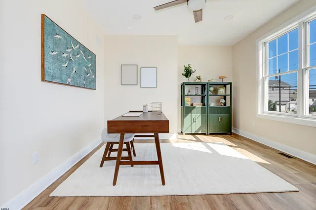 a workspace room with furniture and window