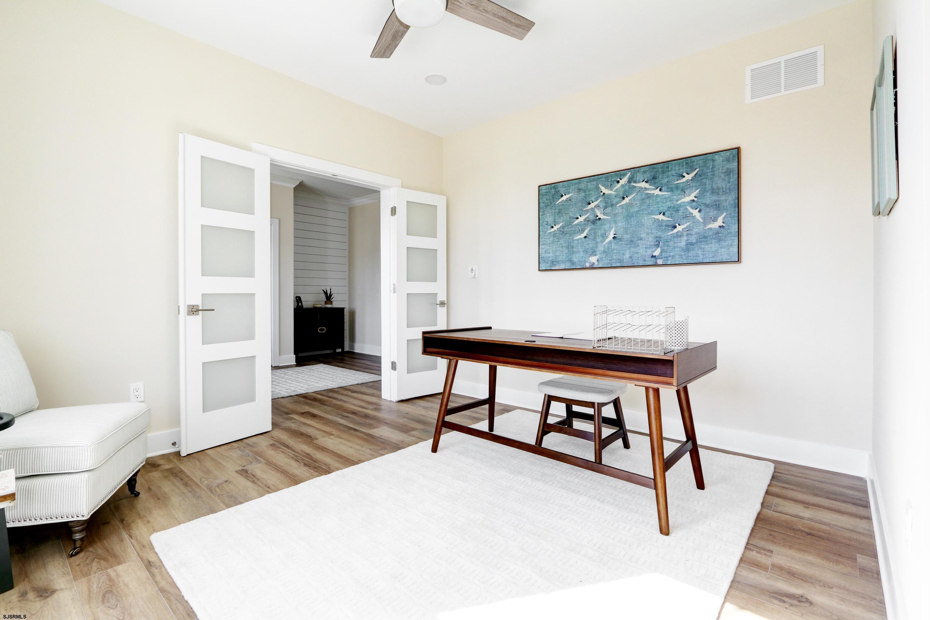 303 Lafayette Place Brigantine, NJ 08203 - Photo 8 of 38 a living room with furniture and a wooden floor