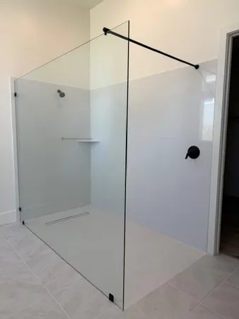 a bathroom with a glass shower door