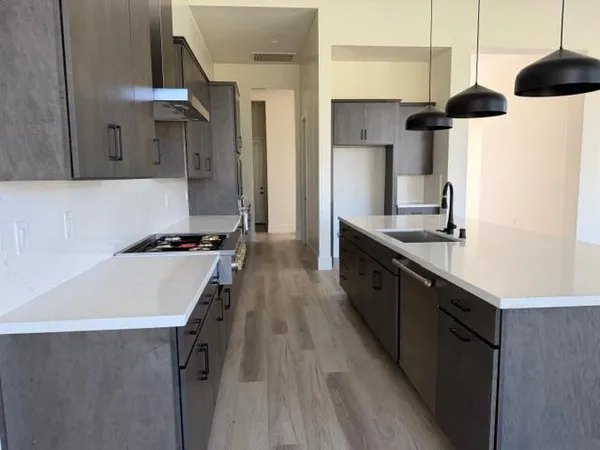a kitchen with a sink a stove and refrigerator