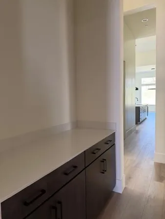 a room with wooden floor and cabinets